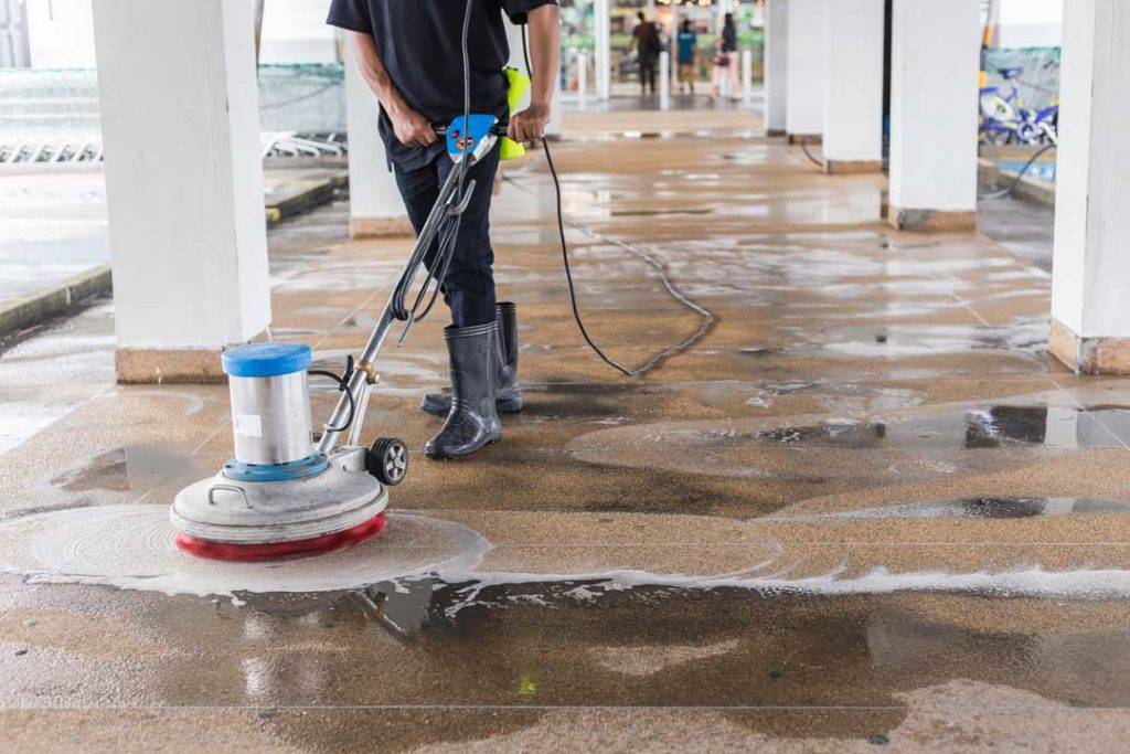 Worker Cleaning Sand Wash Exterior Walkway Using Polishing Machi